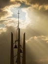 Sunbeams break through the storm clouds behind thi