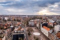 Sunbeams breaking through the cloud deck, with a panorama of Leuven, Flanders, Belgium.