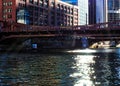 Sunbeams extend over the downtown Chicago Loop, creating glittering stars on the river during morning