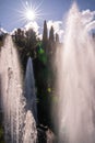 Sunbeams and iridescent reflections in the spray of the fountain of Villa d