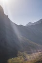 Sunbeams over a mountainous area, a mountain cliff with rocks in the shade in the highlands Royalty Free Stock Photo