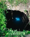 Sunbeams penetrating in opening of Blue cenote