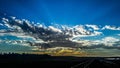 Sunbeams projecting their light on the blue sky