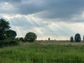 Rays Amidst Clouds Over Countryside Royalty Free Stock Photo