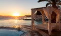 Sunbed and infinity pool at sunset Royalty Free Stock Photo