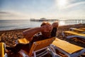 Sunbed on the sand beach, man on it and view to water of sea, pierce and blue sky with white clouds in a nice day, morning or Royalty Free Stock Photo