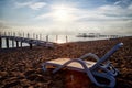 Sunbed on the sand beach and view to water of sea, pierce and blue sky with white clouds in a nice day, morning or evening. The Royalty Free Stock Photo