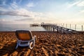 Sunbed on the sand beach and view to water of sea, pierce and blue sky with white clouds in a nice day, morning or evening. The Royalty Free Stock Photo