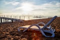 Sunbed on the sand beach and view to water of sea, pierce and blue sky with white clouds in a nice day, morning or evening. The Royalty Free Stock Photo