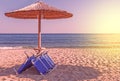 Sunbed, straw umbrella on beautiful beach background Royalty Free Stock Photo