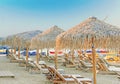 Sunbed, straw umbrella on beautiful rising sun beach