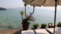 Sunbed and umbrellas on beach. Boat on sea horizon.