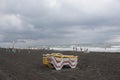 Sunbeds on beach. cloudy weather, overcast. Unidentified people on the beach