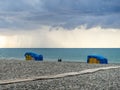 Sunbeds on the beach are placed one on top of the other. Bad weather sea. A big wave. Bathing is not possible Royalty Free Stock Photo