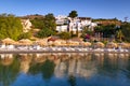 Sunbeds with parasols at Mirabello Bay Royalty Free Stock Photo