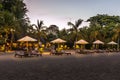 Sunbeds and restaurants on a balinese beach at night