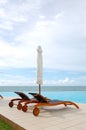 Sunbeds at the sea view swimming pool Royalty Free Stock Photo