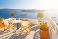 Sunbeds on the terrace of hotel. Santorini island, Greece. Beautiful summer landscape with sea view