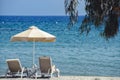 Sunbeds and umbrella on the sandy beach