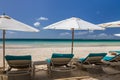 Sunbeds and umbrellas on a white sand beach Royalty Free Stock Photo