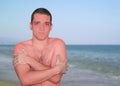 Sunburn skin portrait of young man over beach background