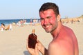 Sunburned man using tanning accelerator lotion Royalty Free Stock Photo