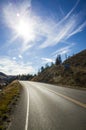 Sunburst above an empty tarred road Royalty Free Stock Photo