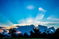 Sunburst behind the clouds with blue sky background Royalty Free Stock Photo