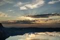 Sunburst Breaks Through Dark Clouds Over Crater Lake Just After Sun Rise Royalty Free Stock Photo