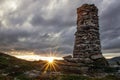 Sunburst and cairn at sunset