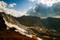 Sunburst through clouds at sunset over Tien shan Royalty Free Stock Photo