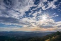 Sunburst and cloudscape above the hills and valleys of Contra Costa county