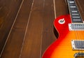 Sunburst electric guitar on wood floor close up Royalty Free Stock Photo