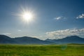 Sunburst Over Mountains and Rolling Hills