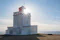 Sunburst shining through the Dyrholaey Lighthouse in Iceland