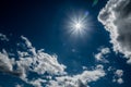 Sunburst of sunlight on clouds and blue sky