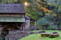 Sunburst at sunrise with old historic grist mill in the foreground in the fall Royalty Free Stock Photo