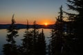 Sunburst Through The Trees Over Crater Lake Royalty Free Stock Photo