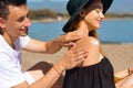 Suncare couple on a summer beach vacation have good skincare with high spf sunblock. Couple applying suncream. Handsome man Royalty Free Stock Photo