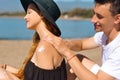 Suncare couple on a summer beach vacation have good skincare with high spf sunblock. Couple applying suncream. Handsome man Royalty Free Stock Photo