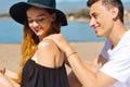 Suncare couple on a summer beach vacation have good skincare with high spf sunblock. Couple applying suncream. Handsome man Royalty Free Stock Photo