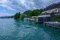 Sunchairs on wooden pier and view of alpine lake Worthersee Royalty Free Stock Photo