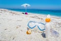 Suncream and diving mask on the sand