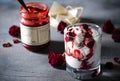 Sundae Ice cream with cherry in chocolate topping, and dried rose flowers on dark background. Love, Valentine`s day