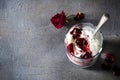 Sundae Ice cream with cherry in chocolate topping, and dried rose flowers on dark background. Love, Valentine`s day