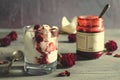 Sundae Ice cream with cherry in chocolate topping, and dried rose flowers on dark background. Love, Valentine`s day