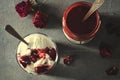 Sundae Ice cream with cherry in chocolate topping, and dried rose flowers on dark background. Love, Valentine`s day