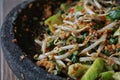 Sundanese raw vegetables salad; served with peanut sauce on stone plate. Close up negative space. Royalty Free Stock Photo