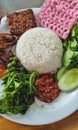 Sundanese traditional food, grilled chicken, chili sauce, raw vegetables