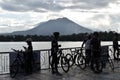 Sunday break, cyclists enjoy the morning sunlight on the lake concrete boardwalk during the height of Covid 19 pandemic general qu Royalty Free Stock Photo